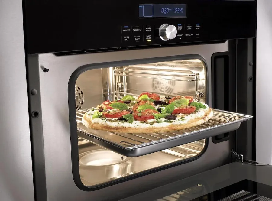 Built-in oven open with a pizza on the rack